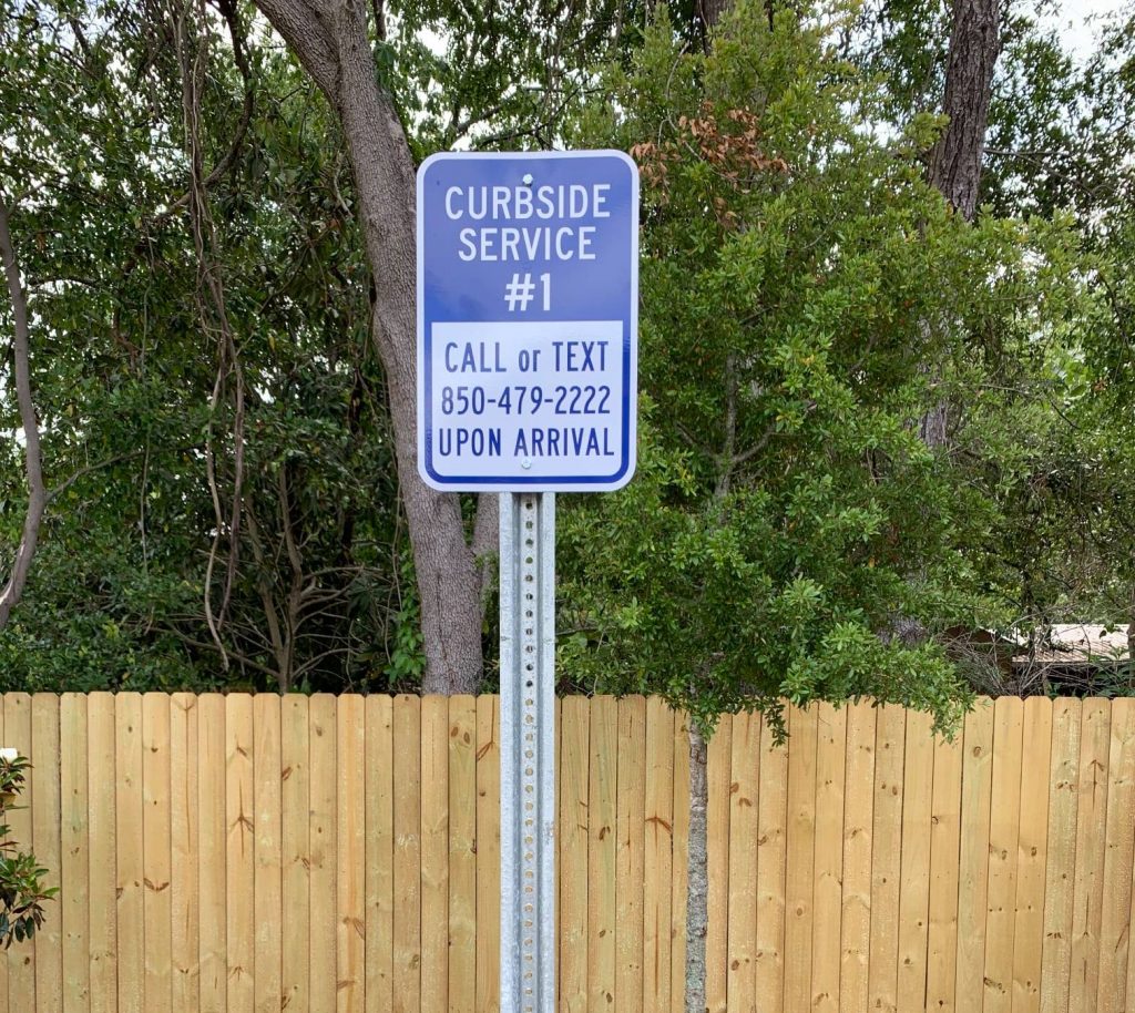 A curbside service parking spot sign at Cordova Animal Medical Center